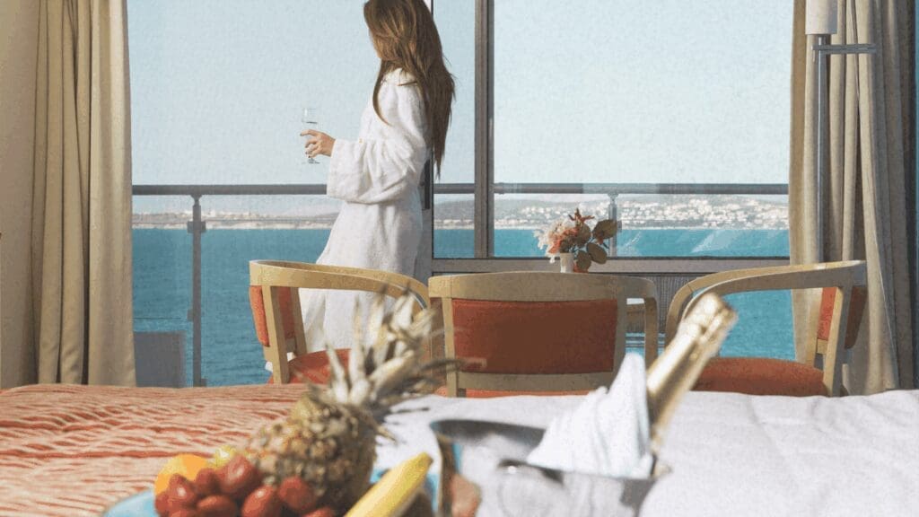 Woman in luxury hotel sipping champagne on Venus line