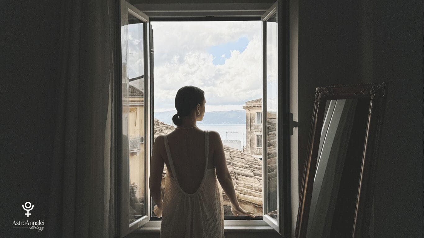 woman looking out window representing Pluto symbolism