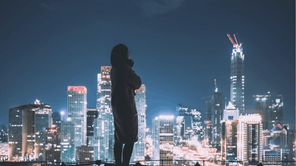 Business woman overlooking city skyline representing Pluto MC line