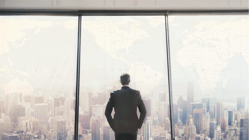 business man overlooking office skyline with an astrocartography map with planetary lines going across the world.